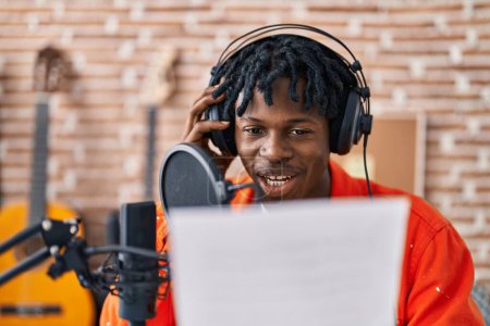 Téléchargez les photos : Africain américain homme musincien chant chanson au studio de musique - en image libre de droit