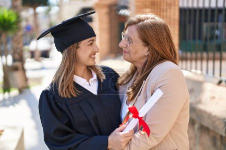 Photo for Mother and daughter hugging each other celebrating graduation at university - Royalty Free Image