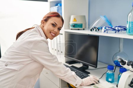 Photo for Young caucasian woman scientist using computer at laboratory - Royalty Free Image