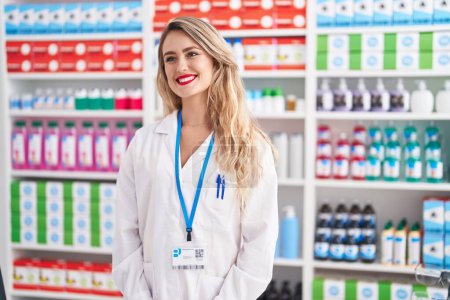 Photo for Young beautiful hispanic woman pharmacist smiling confident standing at pharmacy - Royalty Free Image