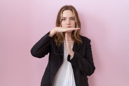 Photo for Young caucasian business woman wearing black jacket doing time out gesture with hands, frustrated and serious face - Royalty Free Image