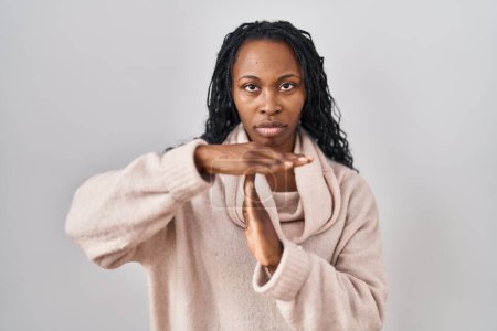 Photo for African woman standing over white background doing time out gesture with hands, frustrated and serious face - Royalty Free Image