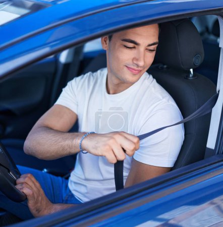 Photo for Young hispanic man smiling confident wearing car belt at street - Royalty Free Image