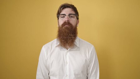 Photo for Young redhead man wearing glasses with relaxed expression over isolated yellow background - Royalty Free Image