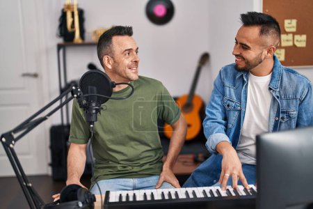 Photo for Two men musicians singing song playing piano at music studio - Royalty Free Image