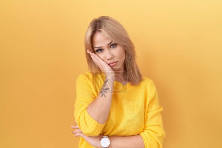 Photo for Young caucasian woman wearing yellow sweater thinking looking tired and bored with depression problems with crossed arms. - Royalty Free Image