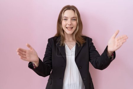 Photo for Young caucasian business woman wearing black jacket looking at the camera smiling with open arms for hug. cheerful expression embracing happiness. - Royalty Free Image
