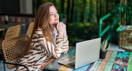 Photo for Young caucasian woman using laptop sitting on table at restaurant - Royalty Free Image
