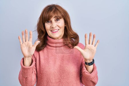 Photo for Middle age hispanic woman standing over isolated background showing and pointing up with fingers number ten while smiling confident and happy. - Royalty Free Image