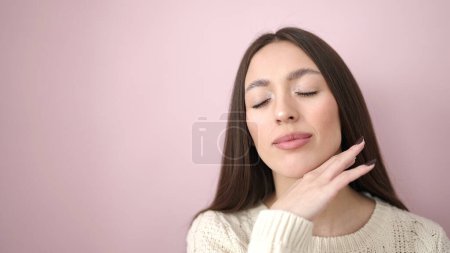 Téléchargez les photos : Young beautiful hispanic woman smiling confident touching face over isolated pink background - en image libre de droit