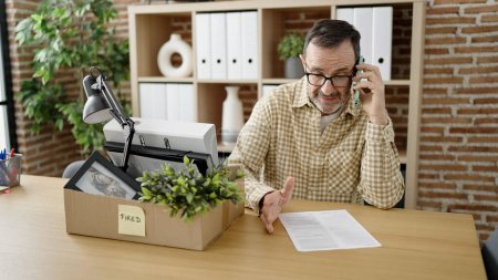 Photo for Middle age man wearing call center agent headset working from home celebrating achievement with happy smile and winner expression with raised hand - Royalty Free Image