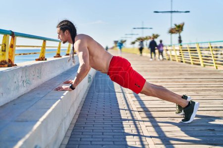 Photo for Young man training at seaside - Royalty Free Image
