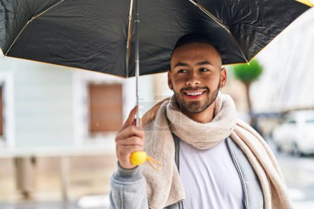 Photo for African american man smiling confident holding umbrella at street - Royalty Free Image