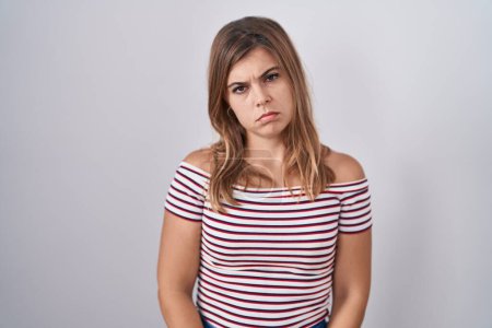 Photo for Young hispanic woman standing over isolated background depressed and worry for distress, crying angry and afraid. sad expression. - Royalty Free Image