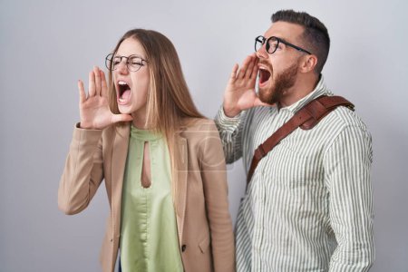 Photo for Young couple standing over white background shouting and screaming loud to side with hand on mouth. communication concept. - Royalty Free Image