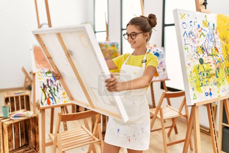 Adorable girl smiling confident looking canvas draw at art studio