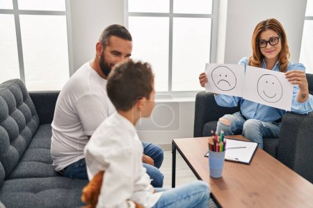 Photo for Family having psychology session looking emotion emoji draw at psychology center - Royalty Free Image