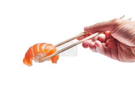 Photo for Hand of man holding salmon nigiri with chopsticks over isolated white background - Royalty Free Image