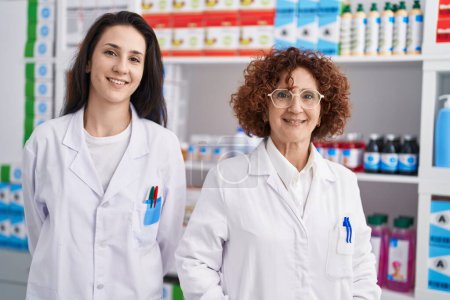 Photo for Two women pharmacists smiling confident standing at pharmacy - Royalty Free Image