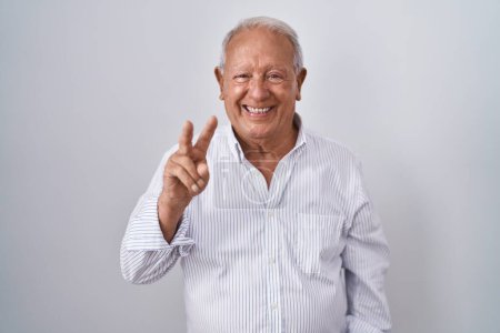Photo for Senior man with grey hair standing over isolated background showing and pointing up with fingers number two while smiling confident and happy. - Royalty Free Image