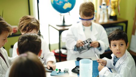 Photo for Group of kids students using microscope repairing gadget at laboratory classroom - Royalty Free Image