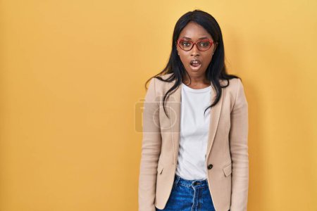 Photo for African young woman wearing glasses afraid and shocked with surprise expression, fear and excited face. - Royalty Free Image
