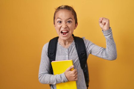Photo for Little caucasian boy wearing student backpack and holding book annoyed and frustrated shouting with anger, yelling crazy with anger and hand raised - Royalty Free Image