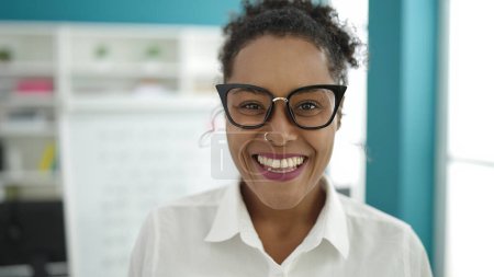 Téléchargez les photos : African american woman student smiling confident standing at library university - en image libre de droit