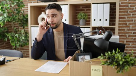 Photo for Young arab man business worker unemployed talking on smartphone at office - Royalty Free Image
