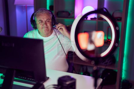 Photo for Middle age grey-haired man streamer smiling confident having video call at gaming room - Royalty Free Image