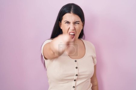 Téléchargez les photos : Young hispanic woman standing over pink background pointing displeased and frustrated to the camera, angry and furious with you - en image libre de droit