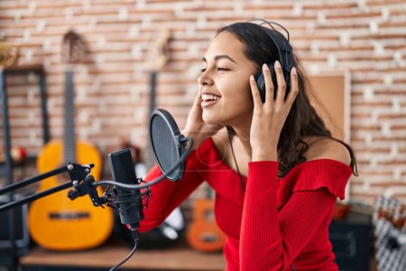 Photo for Young african american woman artist singing song at music studio - Royalty Free Image