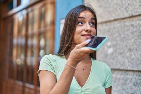 Photo for Young beautiful hispanic woman smiling confident talking on the smartphone at street - Royalty Free Image