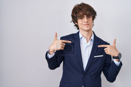 Photo for Hispanic business young man wearing glasses looking confident with smile on face, pointing oneself with fingers proud and happy. - Royalty Free Image