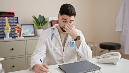 Photo for Young arab man doctor stressed working at clinic - Royalty Free Image