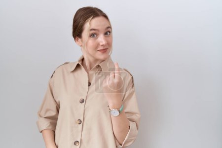 Photo for Young caucasian woman wearing casual shirt beckoning come here gesture with hand inviting welcoming happy and smiling - Royalty Free Image