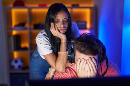 Photo for Man and woman streamers stressed playing video game at gaming room - Royalty Free Image