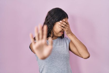 Photo for Young brazilian woman wearing casual t shirt over pink background covering eyes with hands and doing stop gesture with sad and fear expression. embarrassed and negative concept. - Royalty Free Image