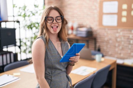 Photo for Caucasian woman working at the office wearing glasses sticking tongue out happy with funny expression. emotion concept. - Royalty Free Image
