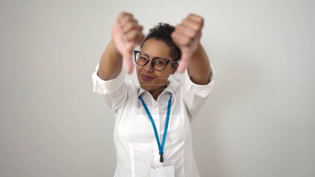 Photo for African american woman doing negative gesture with thumbs down over isolated white background - Royalty Free Image