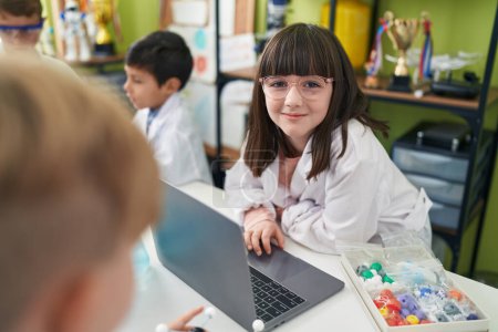 Photo for Adorable boy and girl scientist student using laptop at laboratory classroom - Royalty Free Image