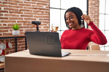 Photo for Young african american with braids showing keys of new home doing video call smiling with a happy and cool smile on face. showing teeth. - Royalty Free Image