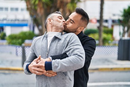 Téléchargez les photos : Two men couple hugging each other kissing at street - en image libre de droit