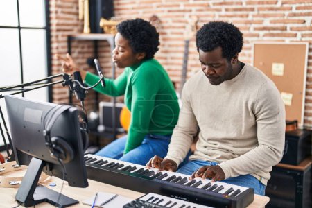 Photo for African american man and woman music group singing song playing keyboard piano at music studio - Royalty Free Image