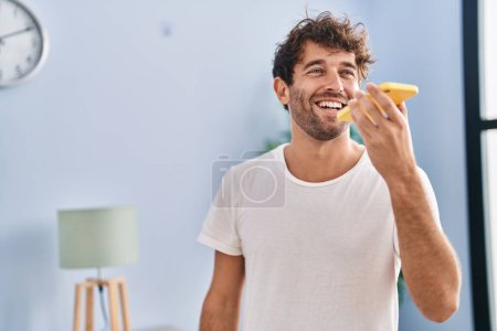 Photo for Young man smiling confident talking on smartphone at home - Royalty Free Image