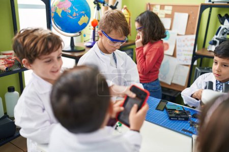 Photo for Group of kids students using microscope repairing smartphone at laboratory classroom - Royalty Free Image