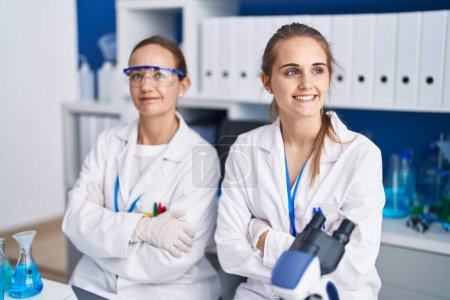 Photo for Two women scientists smiling confident with arms crossed gesture at laboratory - Royalty Free Image