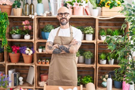 Photo for Young bald man florist smiling confident standing with arms crossed gesture at florist - Royalty Free Image