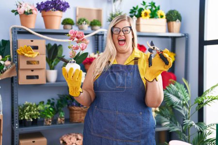 Photo for Caucasian plus size woman working at florist shop celebrating crazy and amazed for success with open eyes screaming excited. - Royalty Free Image