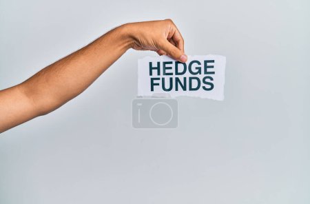 Téléchargez les photos : Hand of caucasian man holding paper with hedge funds message over isolated white background - en image libre de droit